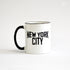 White coffee mug with black lettering of NEW YORK CITY - view with black handle on the left side