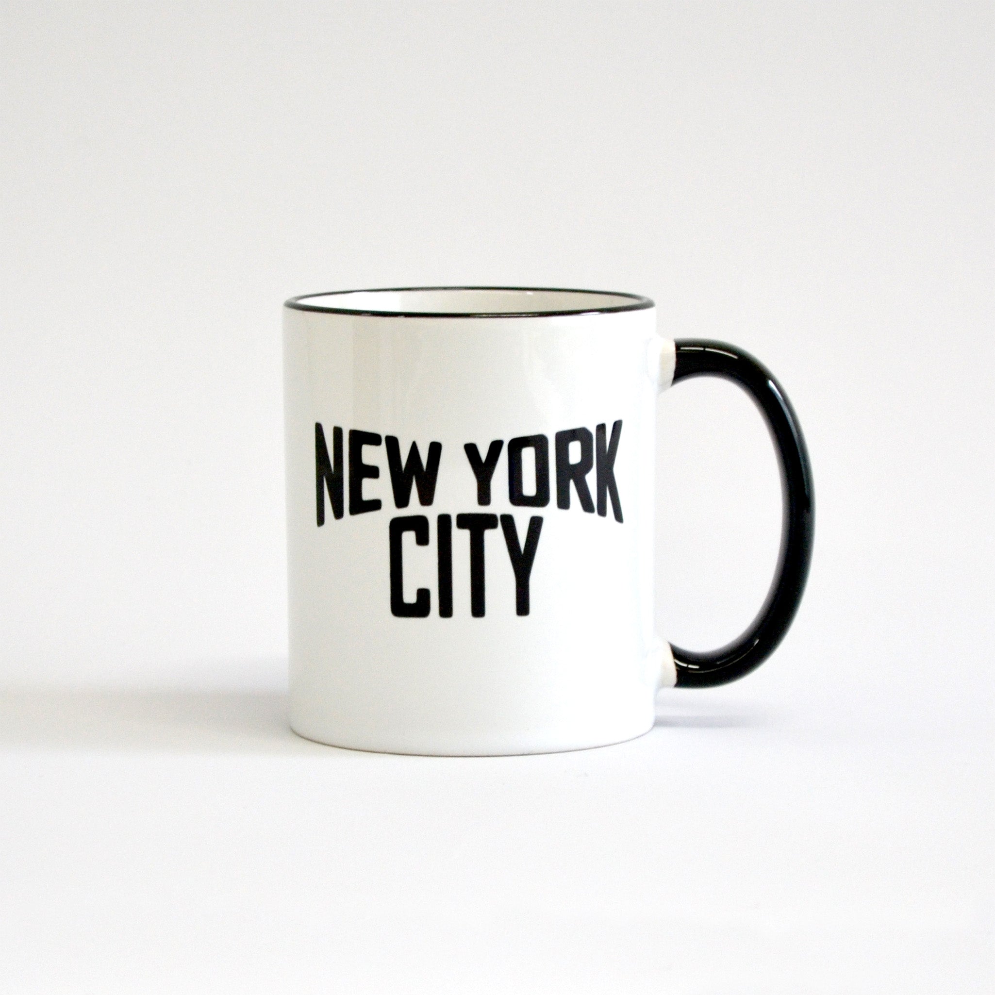 White coffee mug with black lettering of NEW YORK CITY - view with black handle on the right side