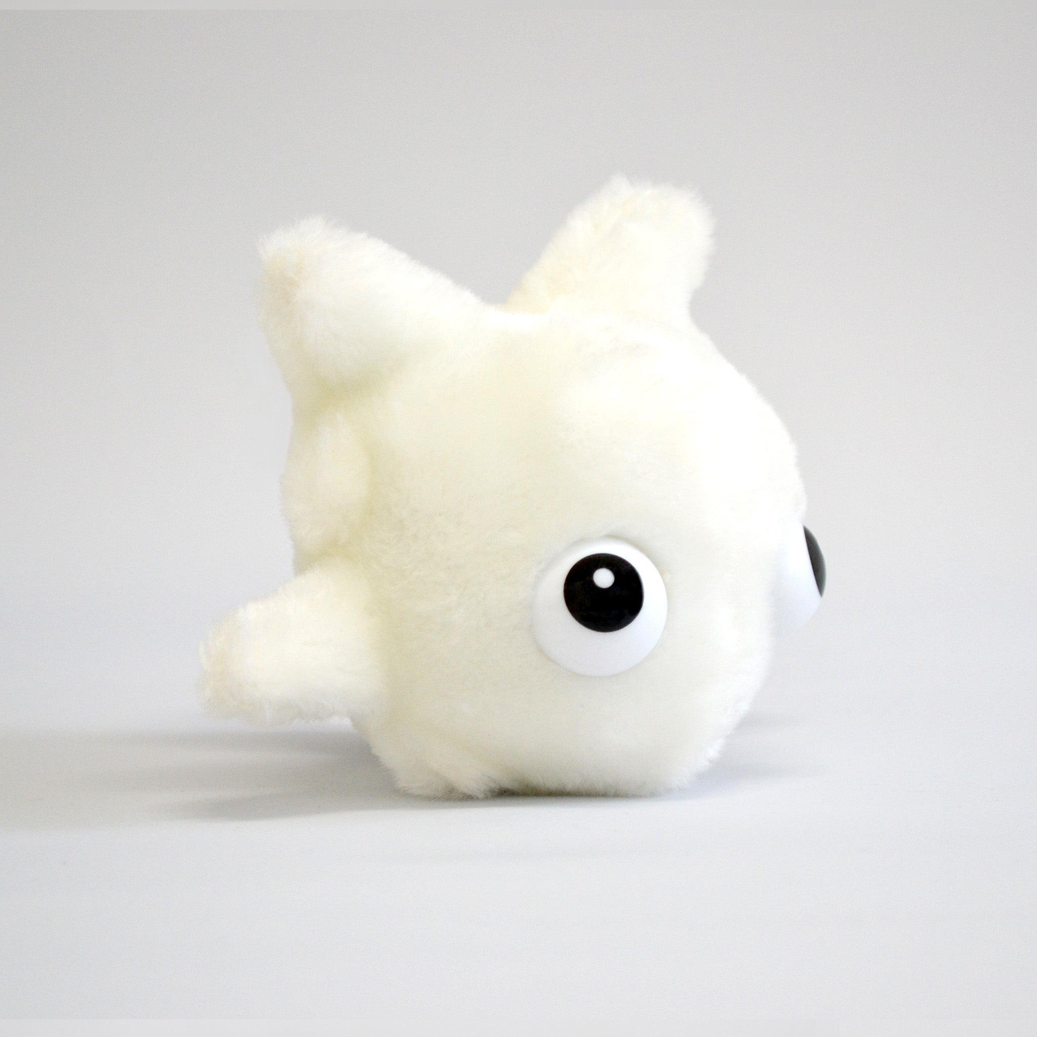Plush white blood cell on white background with big eyes