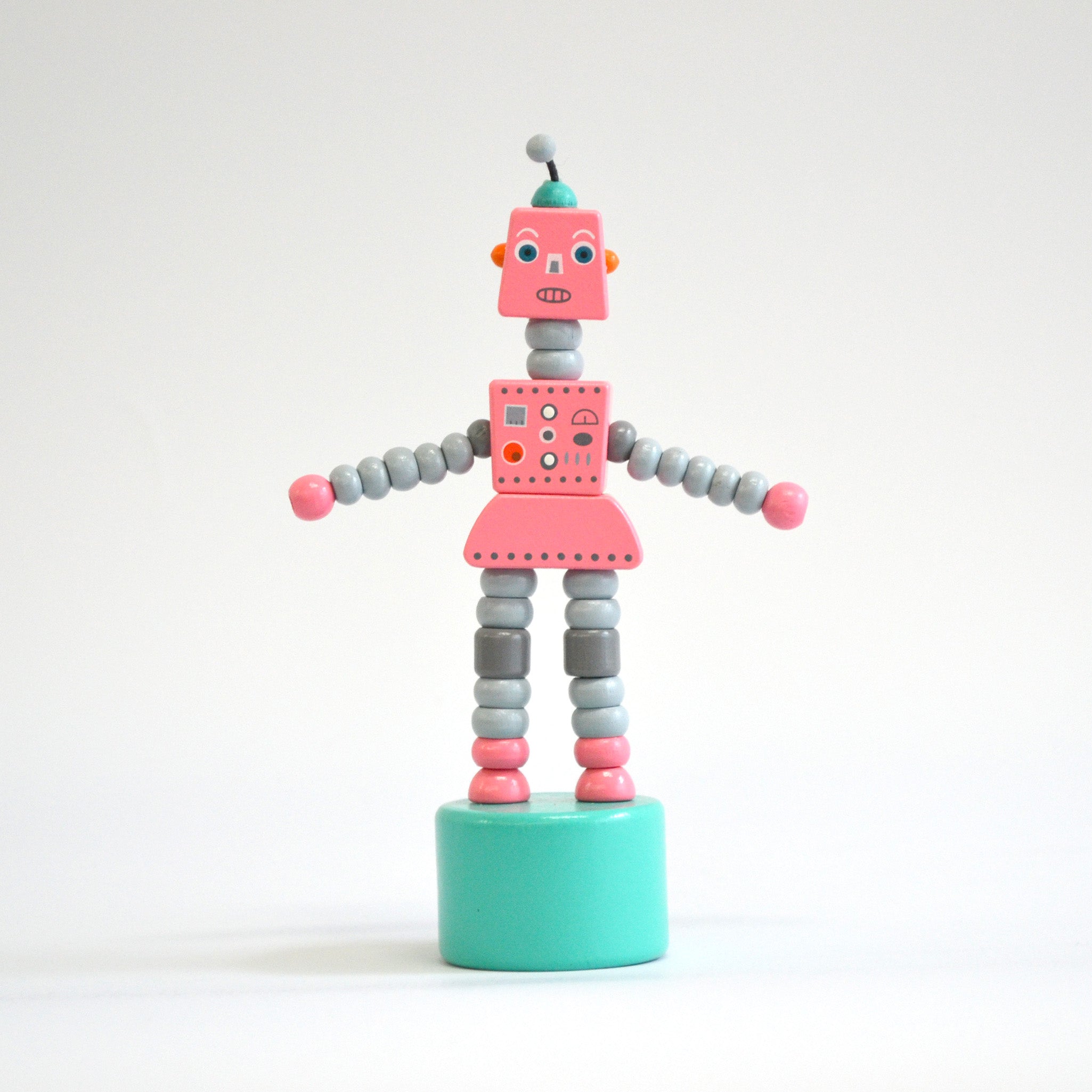Pink toy robot front view on white background