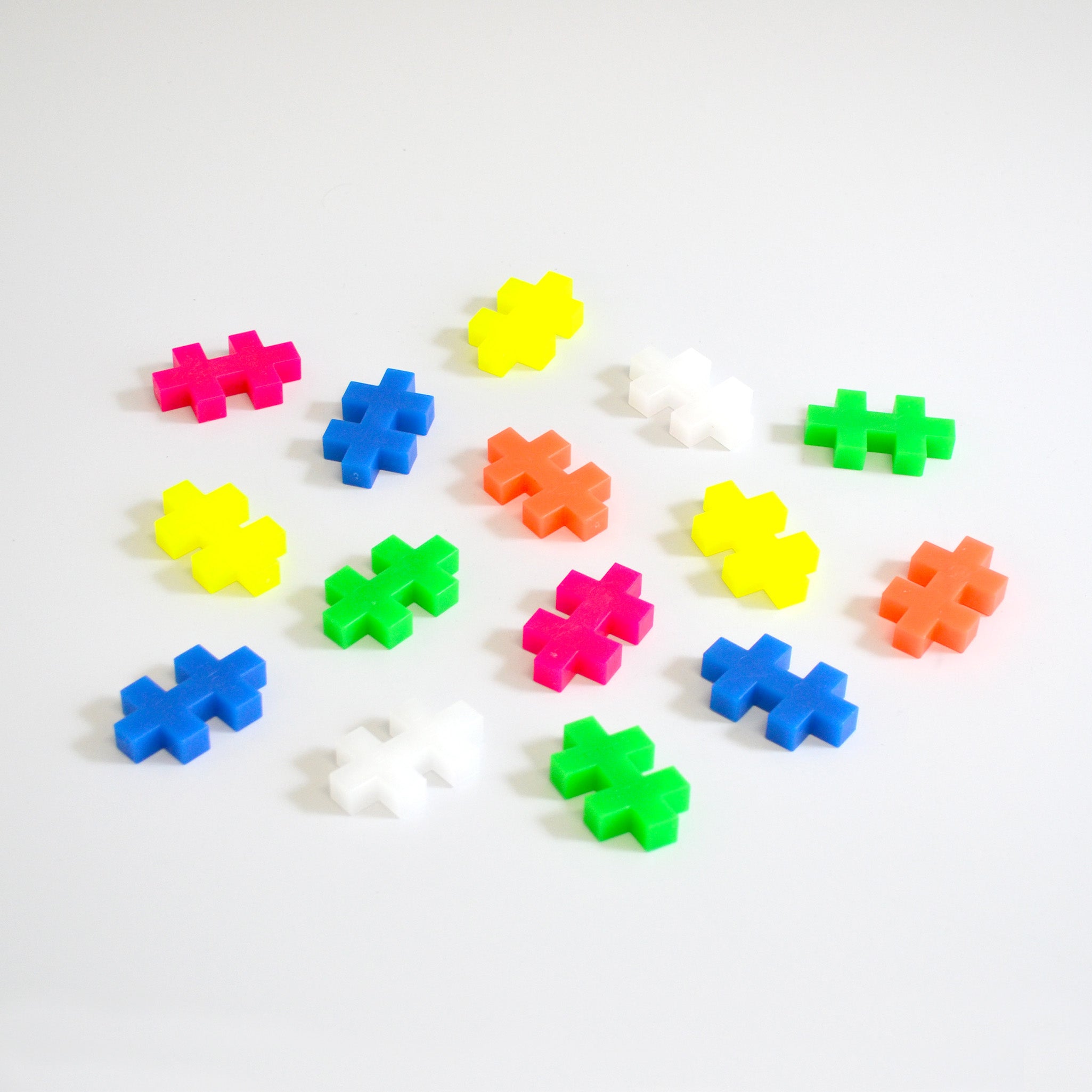 Collectoin of neon colored block puzzle pieces on white background