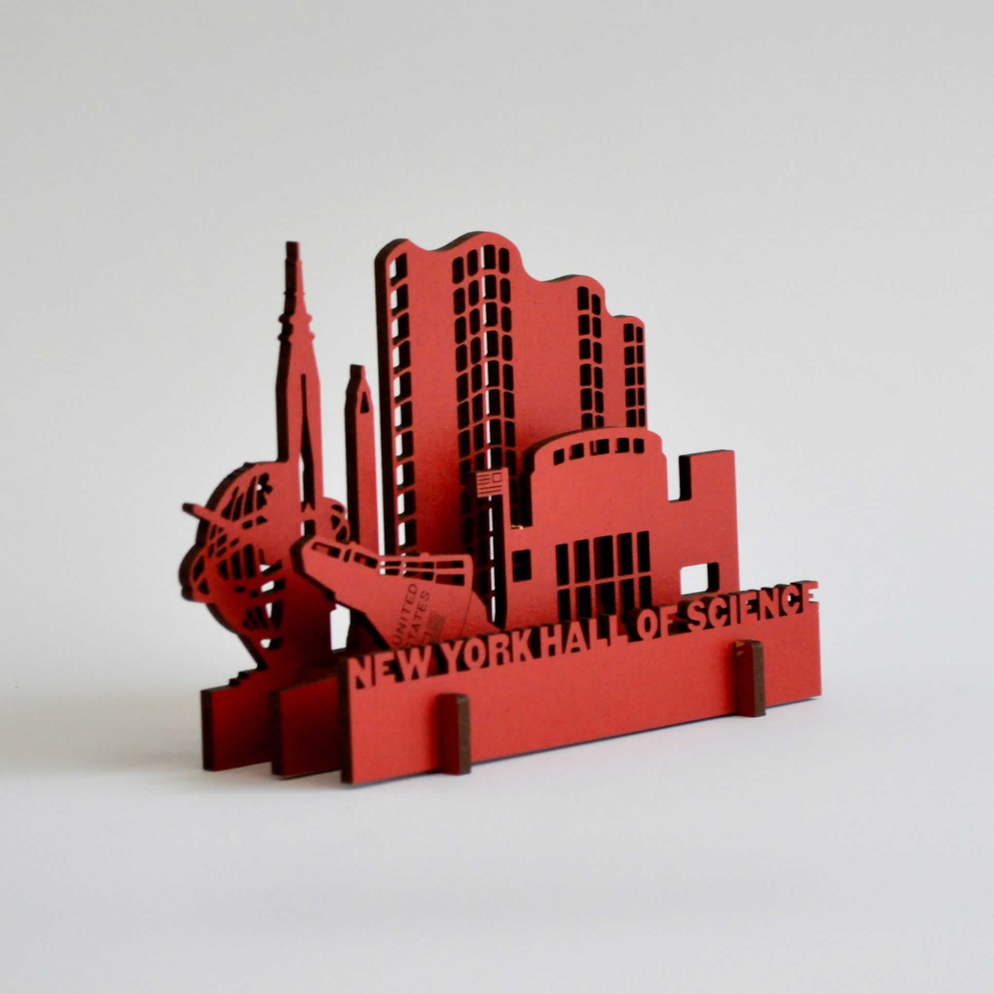 Red wooden puzzle toy resembling the buildings of the museum of science