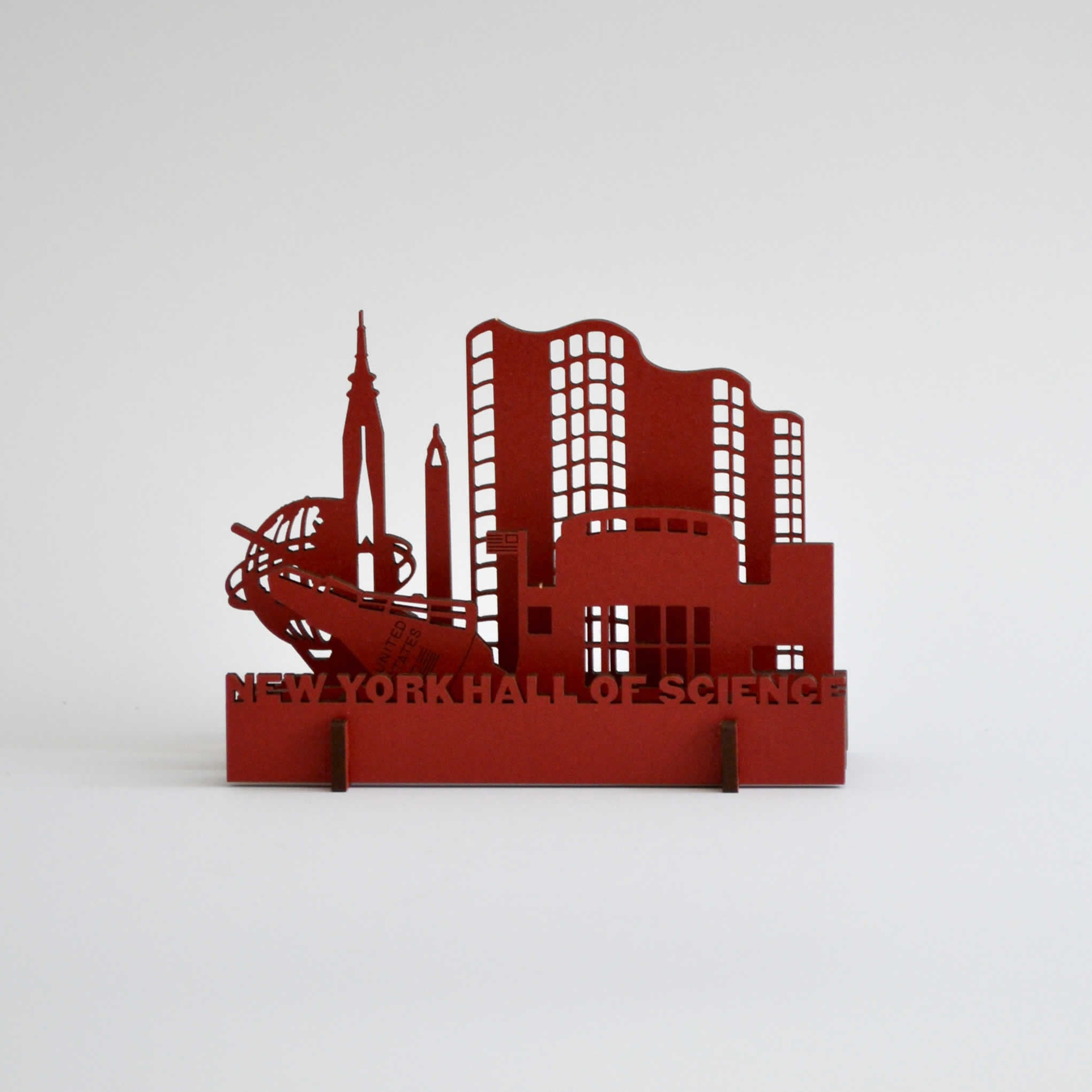 Red wooden puzzle toy resembling the buildings of the museum of science