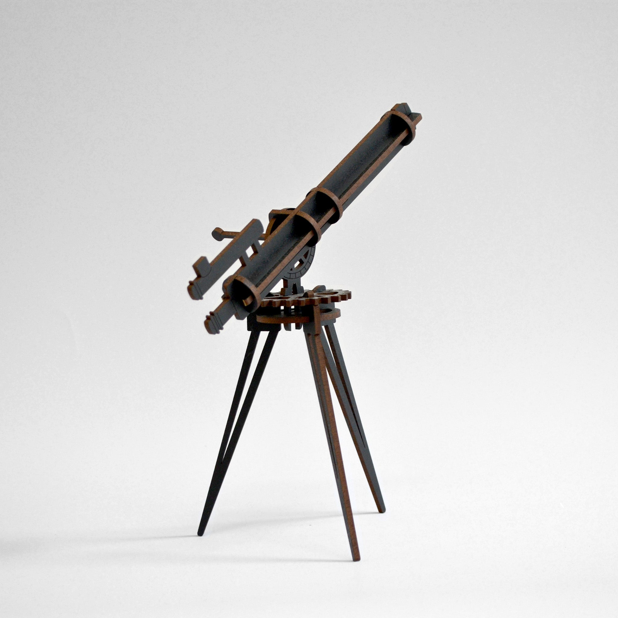 Black wooden telescope built and standing on white background