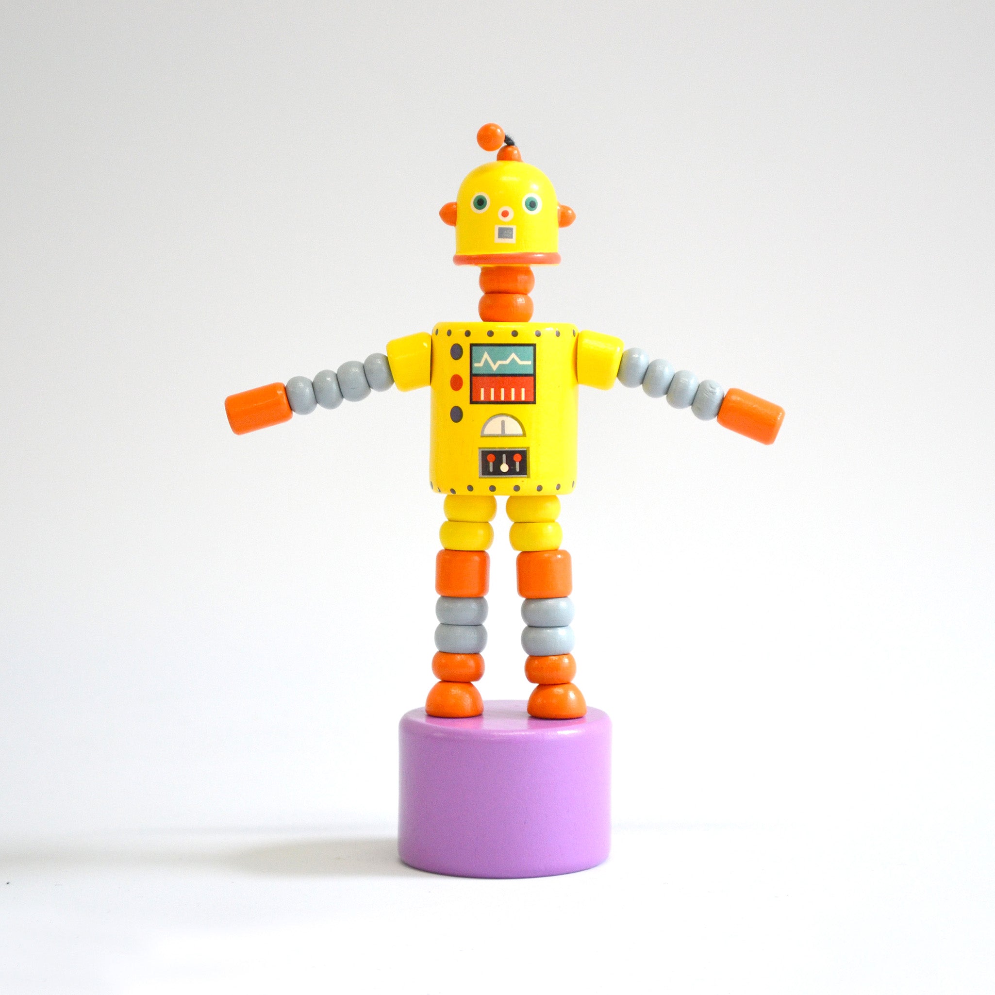 Yellow toy robot front view on white background