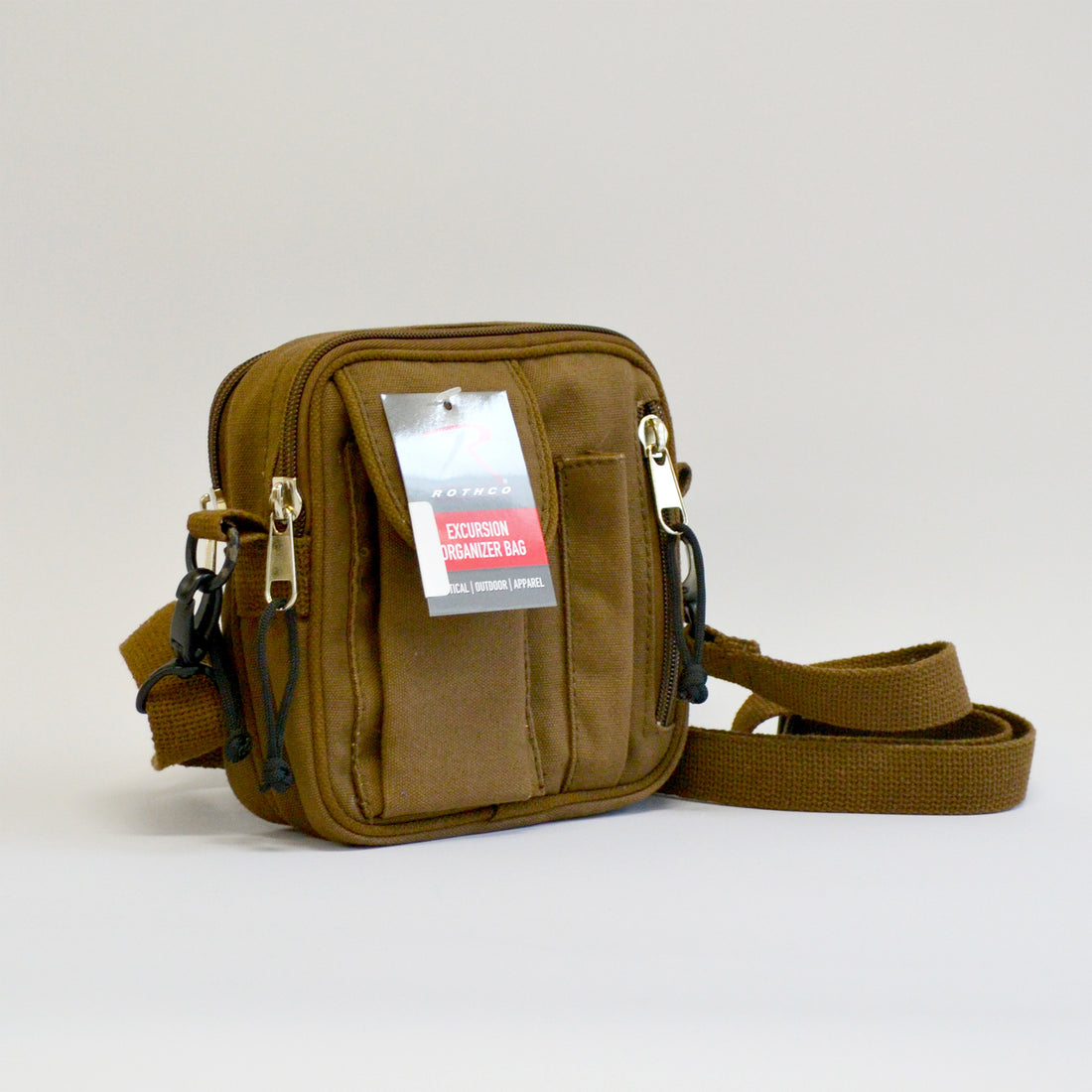 Small brown bag with a flap pocket, a pencil skinny pocket and a zipper on the right side with the adjustable strap showing. Right side facing image