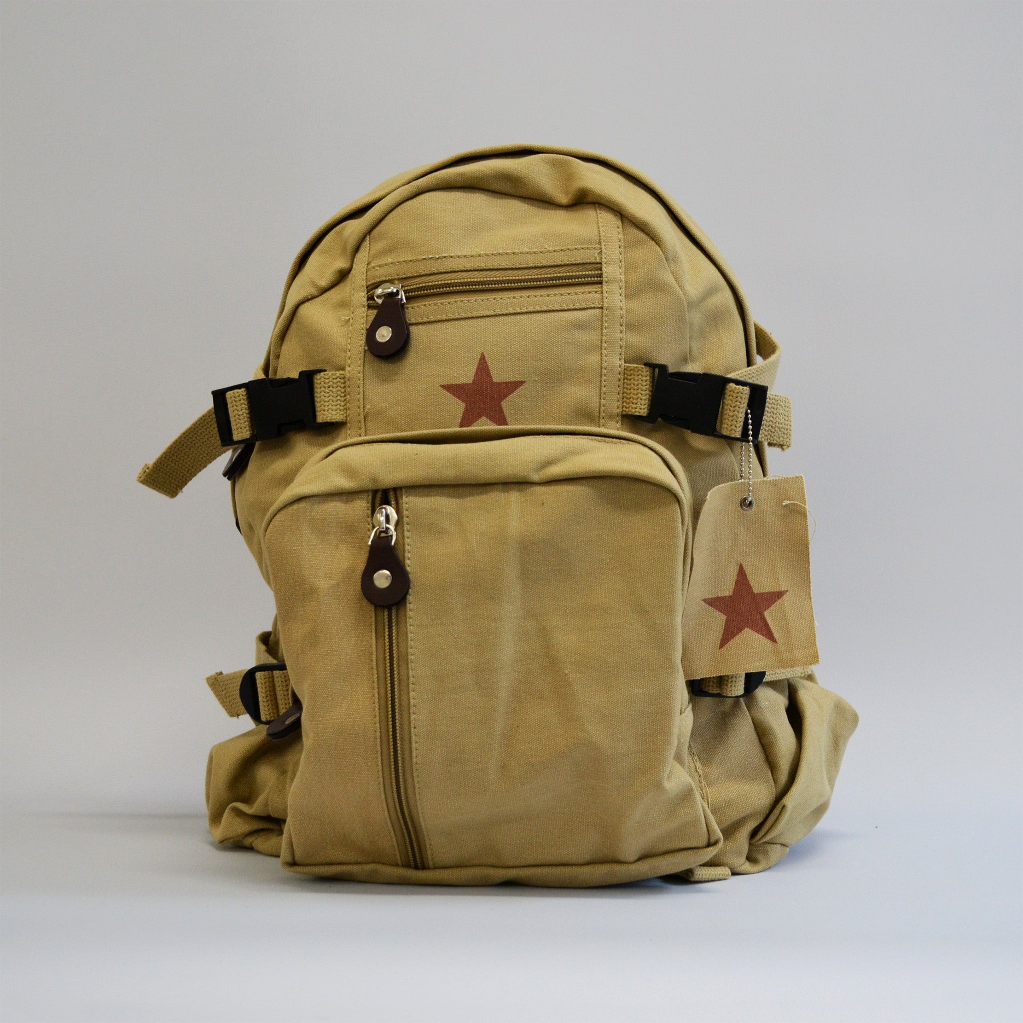 Khaki colored backpack with a star showcased and two buckles on both sides and a small and medium zipper in front. Front facing