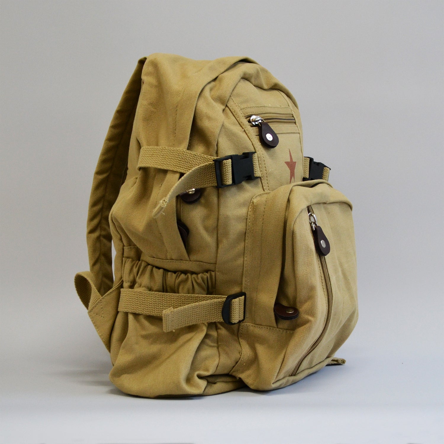 Khaki colored backpack with a buckle, a water bottle holder, facing the right side