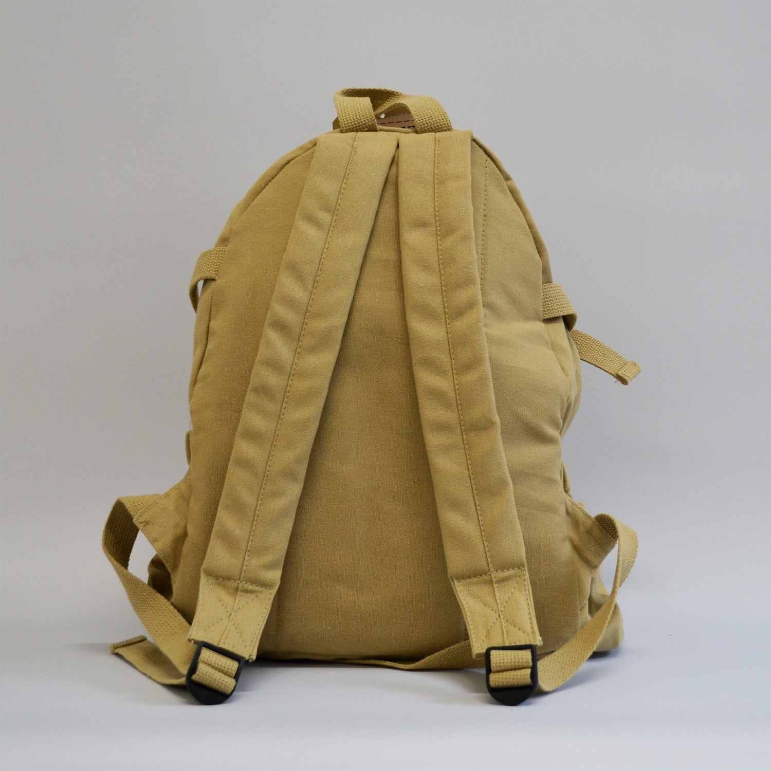 Khaki colored backpack with two wide straps facing away from the screen