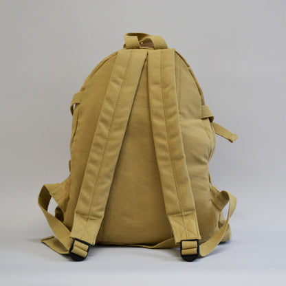 Khaki colored backpack with two wide straps facing away from the screen