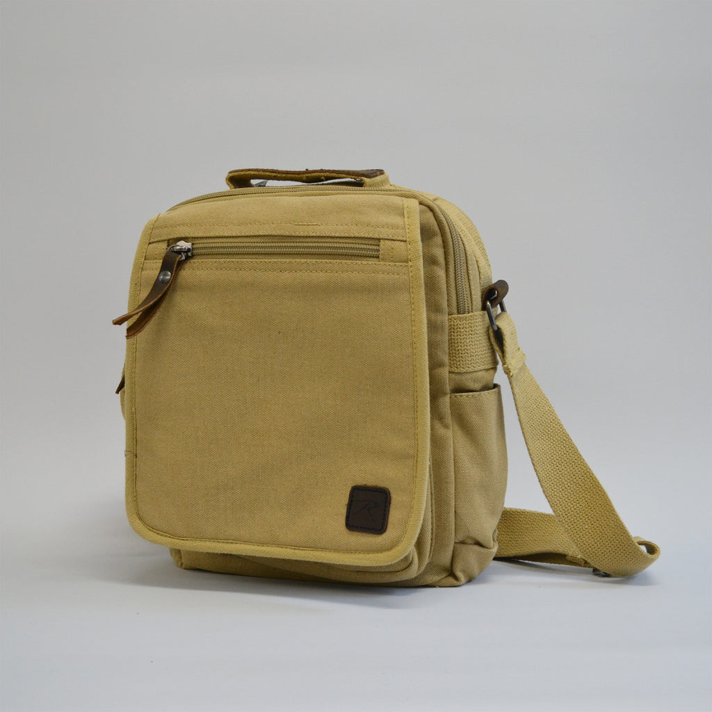 Khaki colored bag with a front zipper and a slightly larger zipper, facing a little to the left 