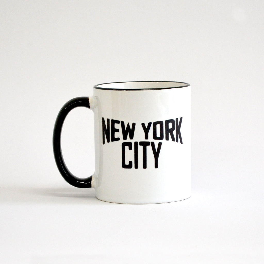 White coffee mug with black lettering of NEW YORK CITY - view with black handle on the left side
