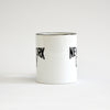 White coffee mug with black lettering of NEW YORK CITY - side view partially showing the words on the left and right