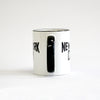 White coffee mug with black lettering of NEW YORK CITY - view of handle side
