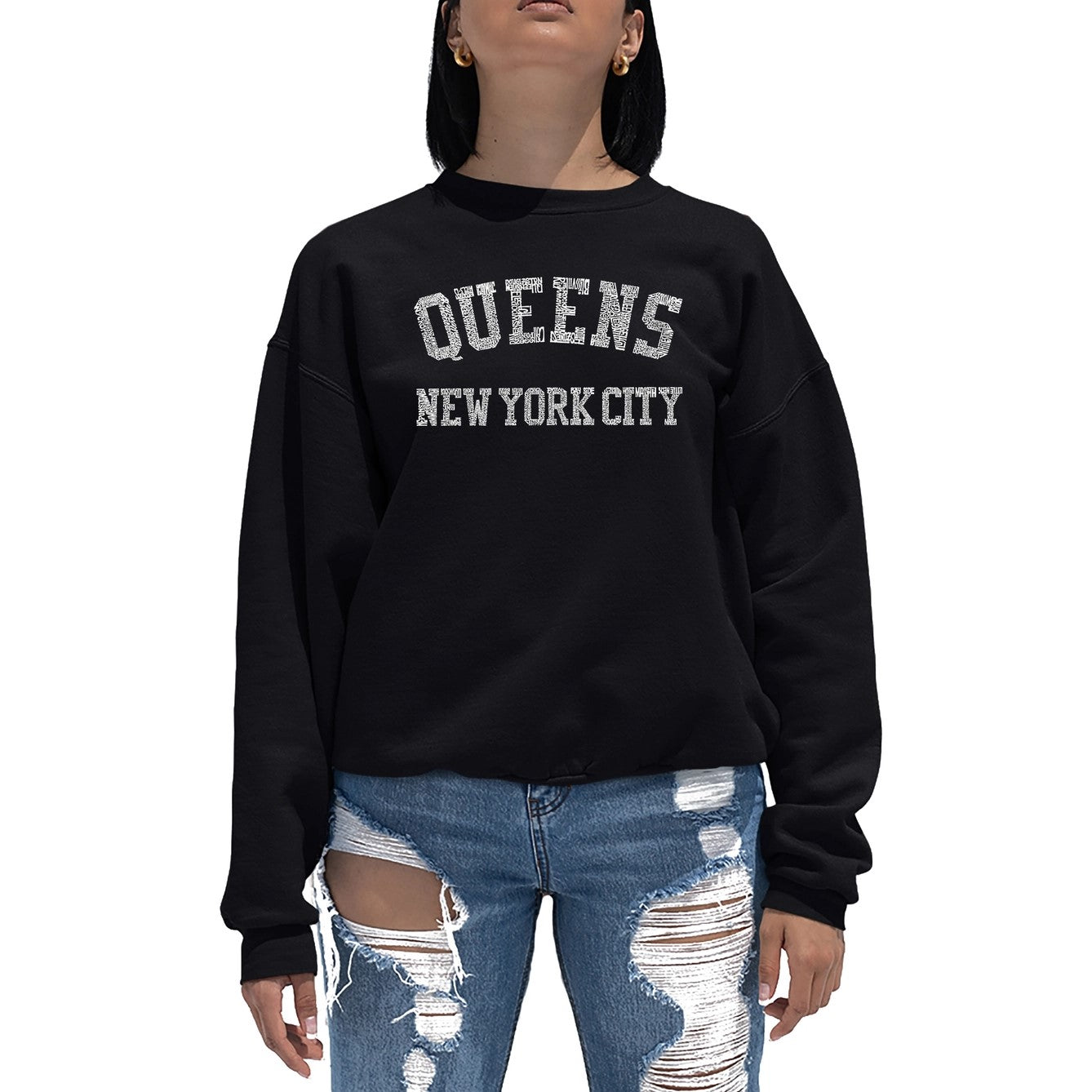 Woman in black sweatshirt with the design of Words Queens, New York City written out in smaller words of the areas of Queens