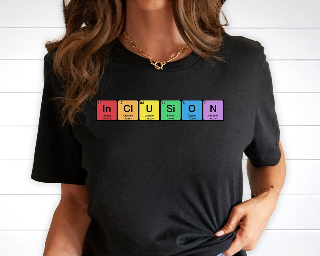Womans blak t-shirt with the elemental letters on it spelling out in-cl-u-si-o-n