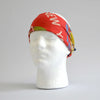 White foam head modelling the red World's Fair head scarf