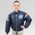 Child wearing the NASA jacket smiling and showing off the NASA patches on the jacket