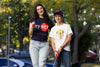 girl and boy playing golf wearing nysci t-shirt and cap
