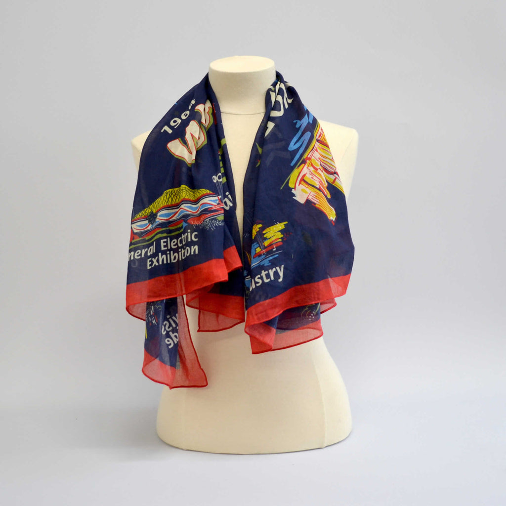 Blue scarf displaying images of the world's fair buildings draped over a mannequin