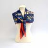 Blue scarf displaying images of the world's fair buildings draped over a mannequin tied in the front