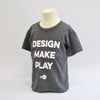 Medium grey round neck t-shirt with the words "design make play" in a large bold font with the NYSCI brand below it. Left side facing image