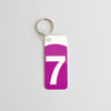 Keychain with the logo of the 7 train in purple