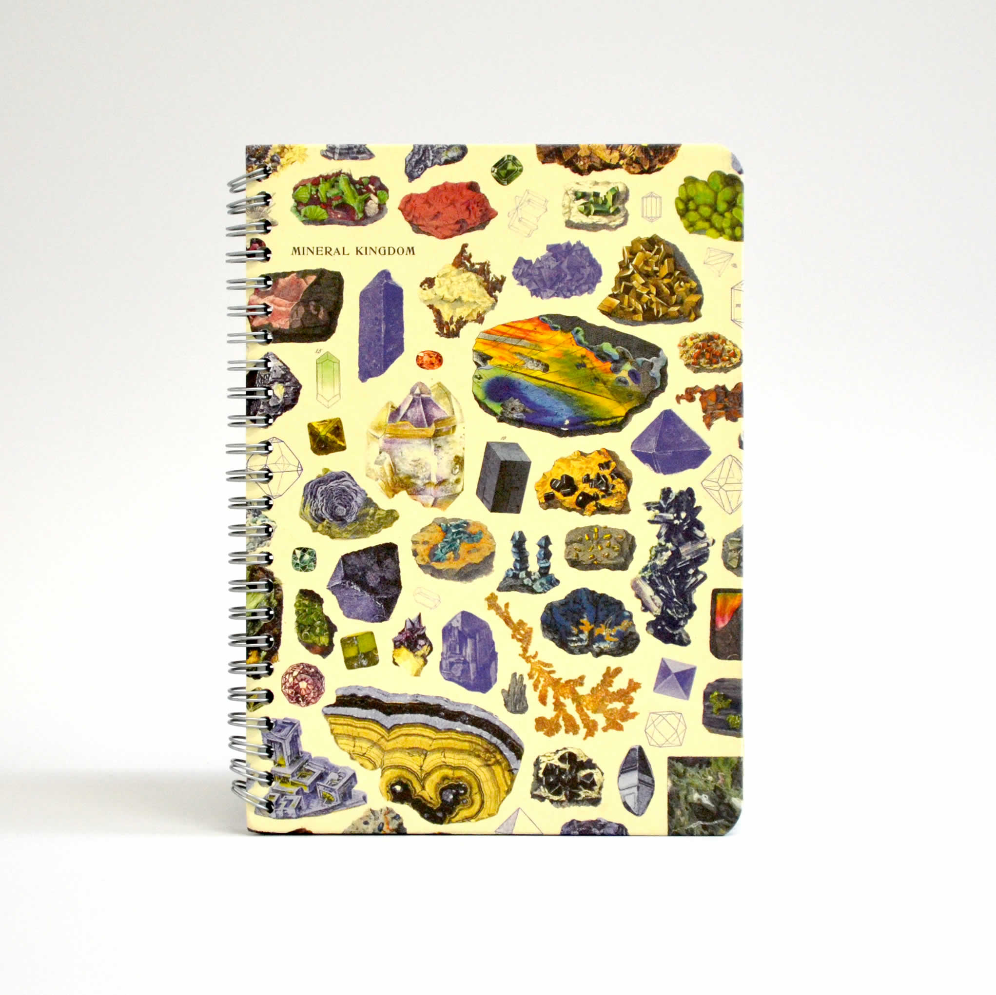 Front of a notebook with images of gems and minerals on a yellow background