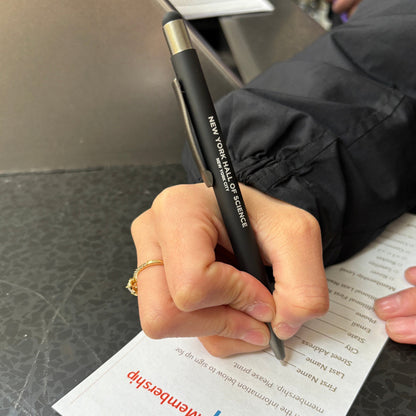 Black pen with the words New York Hall of Science on it in someone&