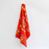 Red tea towel with images of the world&