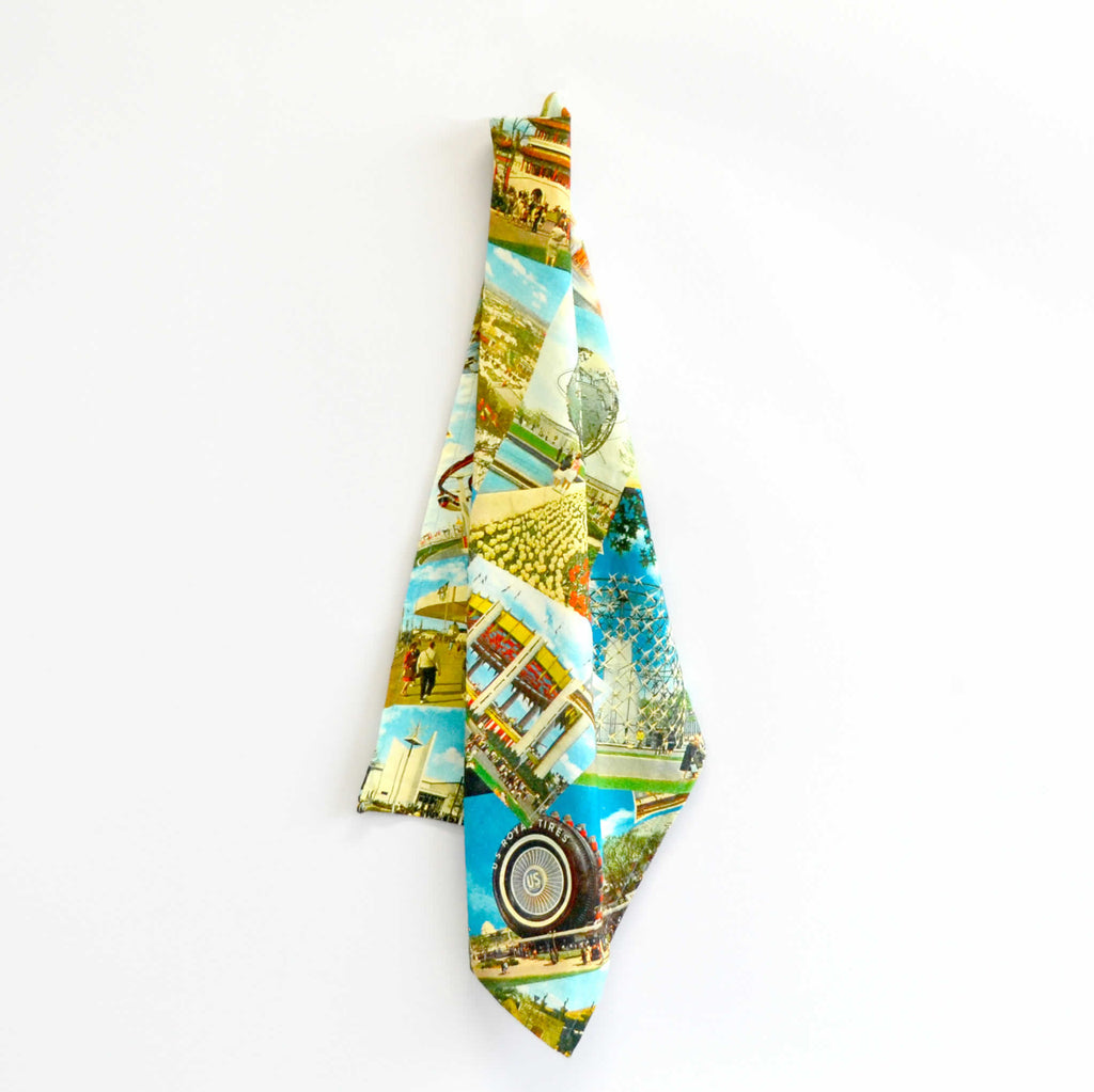 Colorful tea towel draped with vintage postcard images in its design