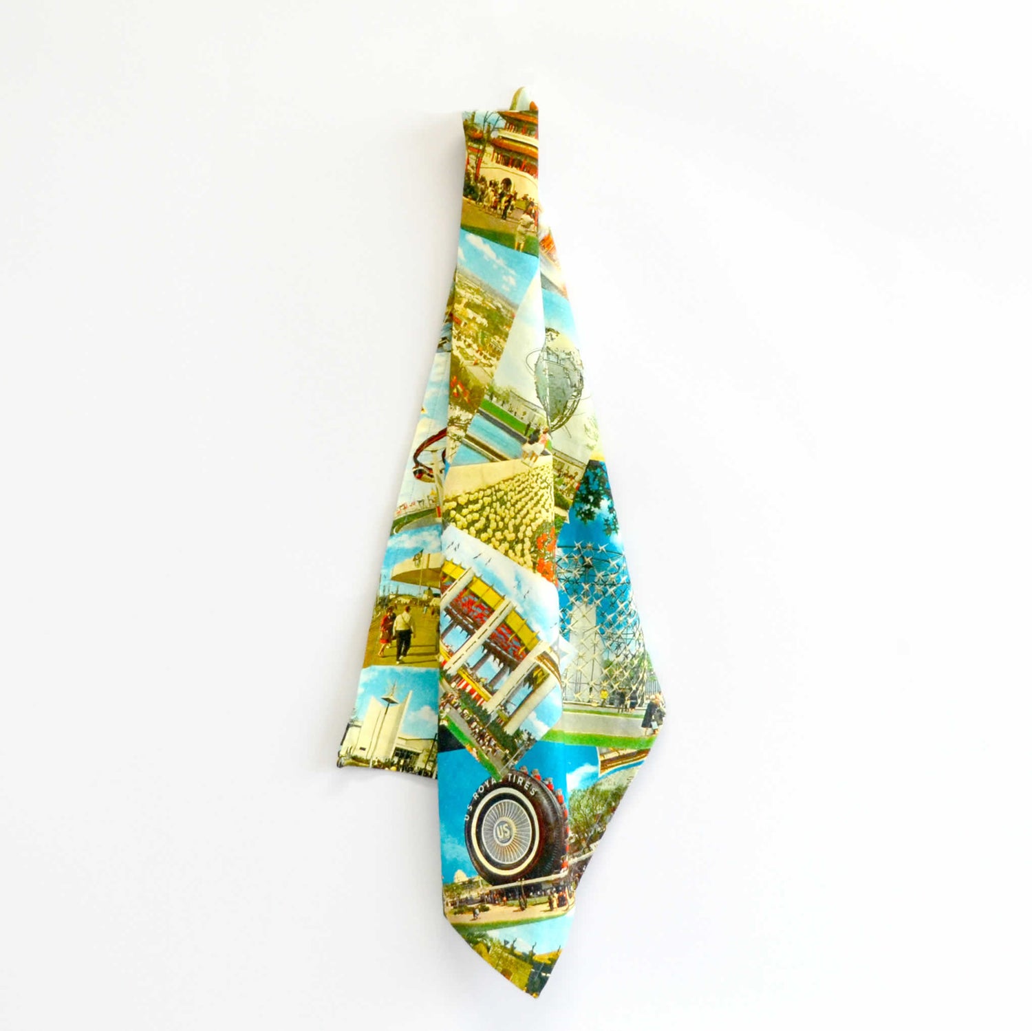 Colorful tea towel draped with vintage postcard images in its design