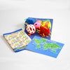 Contents of Giant Microbes toy showing plush microbes, a world map and a book