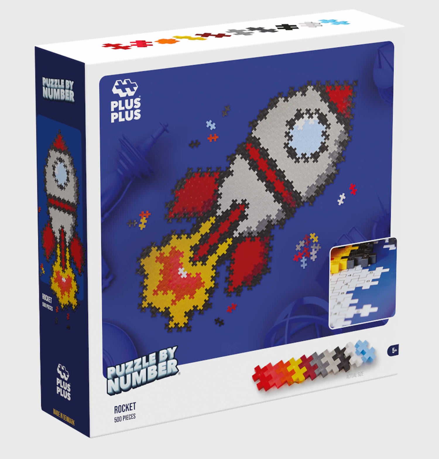 Packaging for Toy Plastic puzzle pieces laid out to form a cartoon image of a rocket