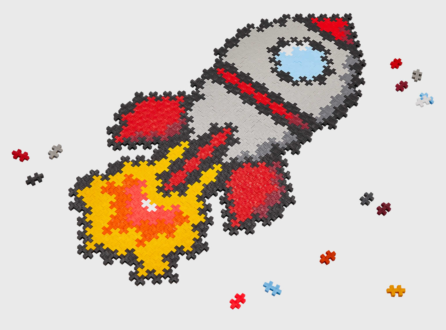 Toy Plastic puzzle pieces laid out to form a cartoon image of a rocket