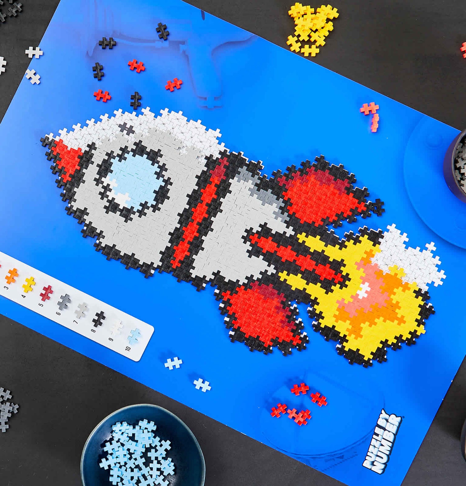 Toy Plastic puzzle pieces laid out to form a cartoon image of a rocket