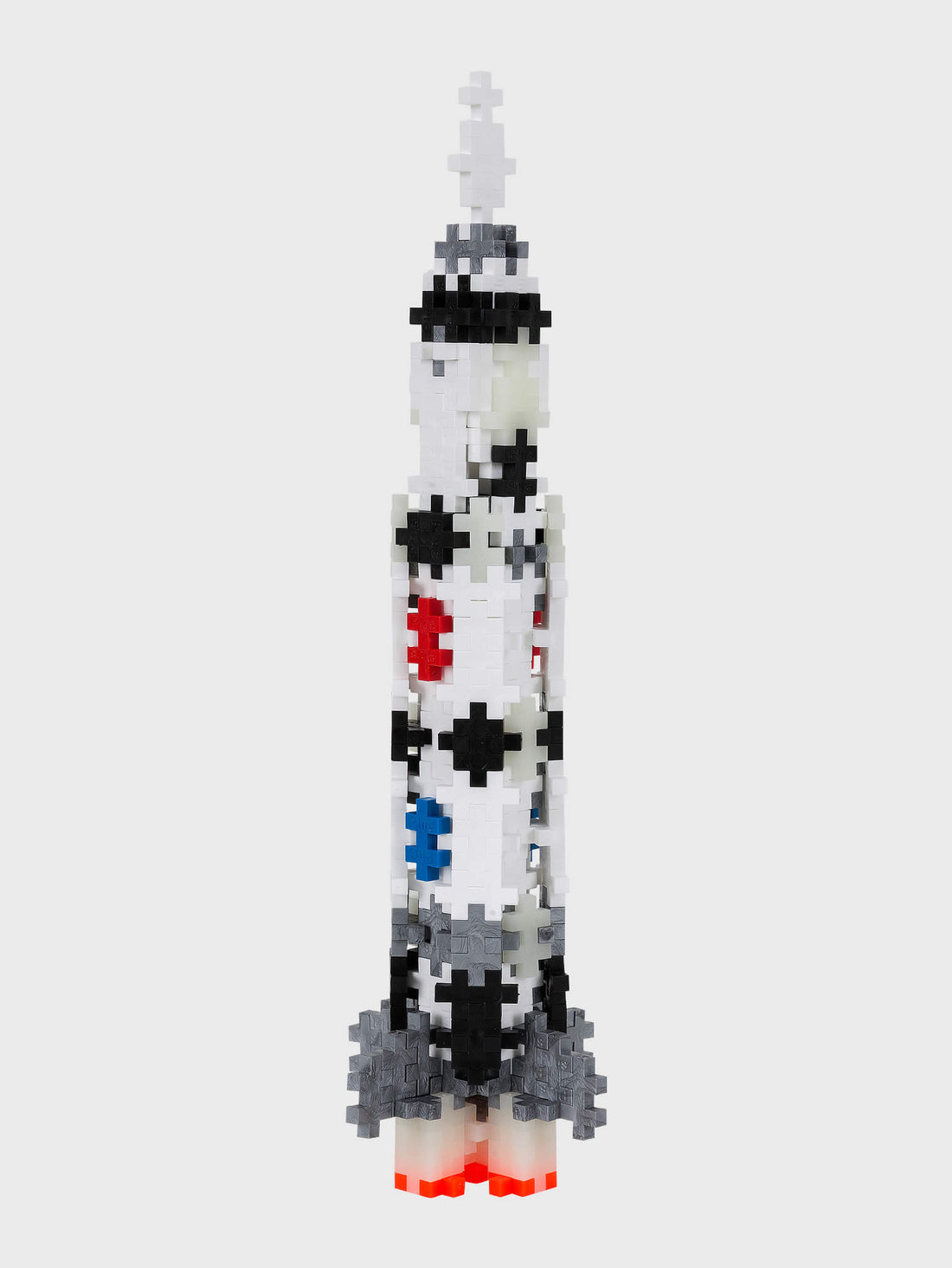 White, Black and red plastic puzzle plus-shaped pieces making up to look like a NASA rocket