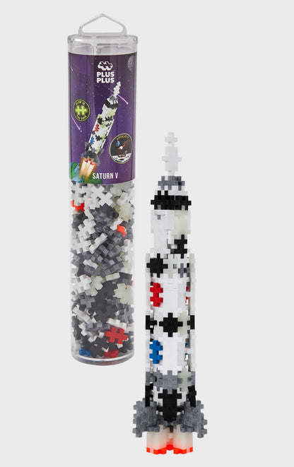 White, Black and red plastic puzzle plus-shaped pieces making up to look like a NASA rocket