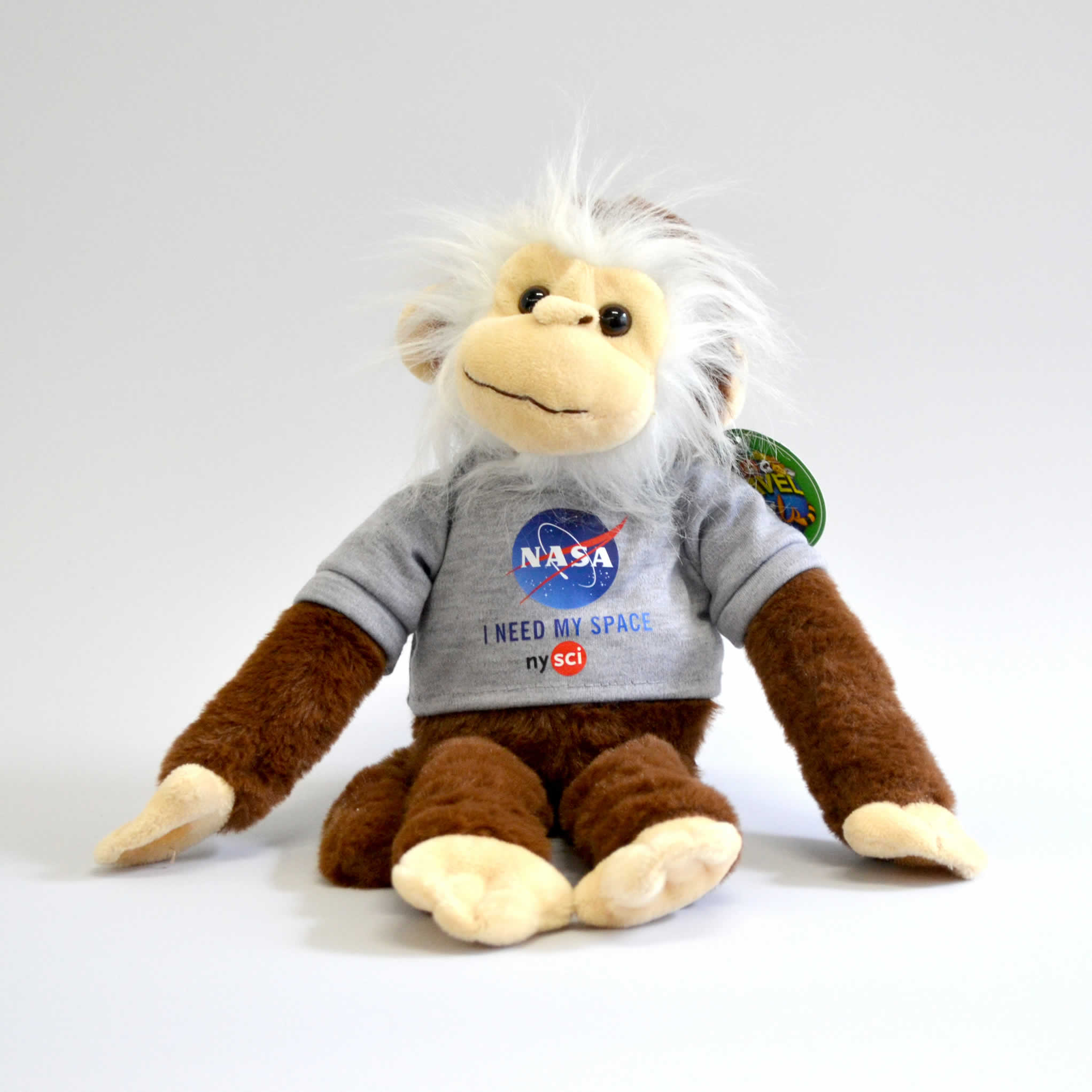 Stuffed animal chimp smiling and wearing a NASA t-shirt