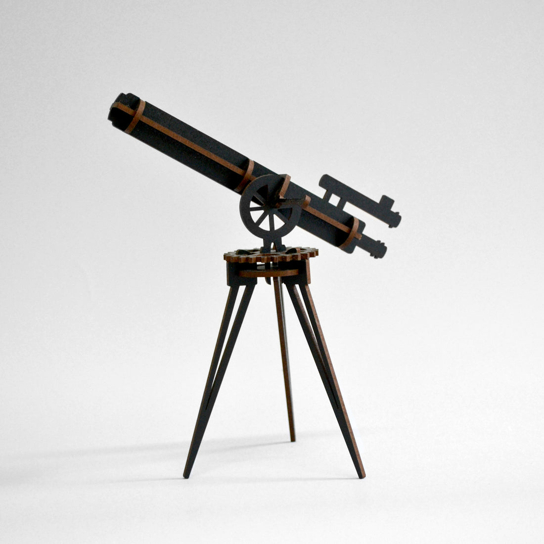 Black wooden telescope built and standing on white background