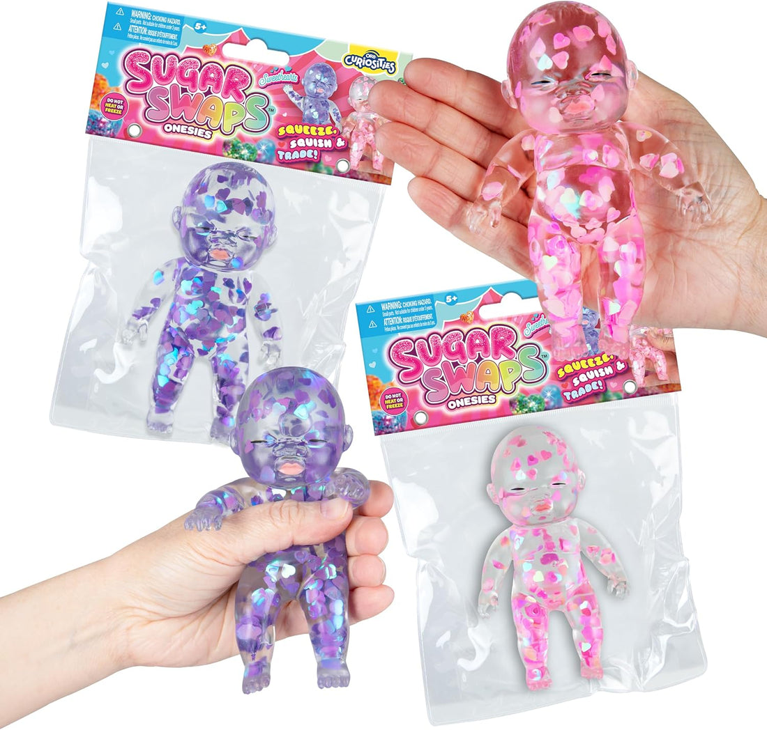 Sugar Swaps package with blue and pink sparkly baby. Two hands holding both colors on each side.